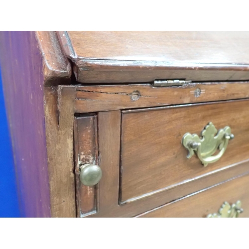 126 - A Georgian mahogany Bureau fitted two short and three long drawers mounted upon shallow bracket feet... 