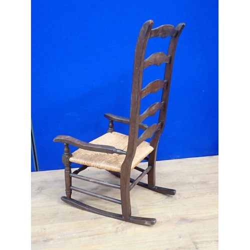 137 - A stained beech rush seated Rocking Chair 3ft 8in H