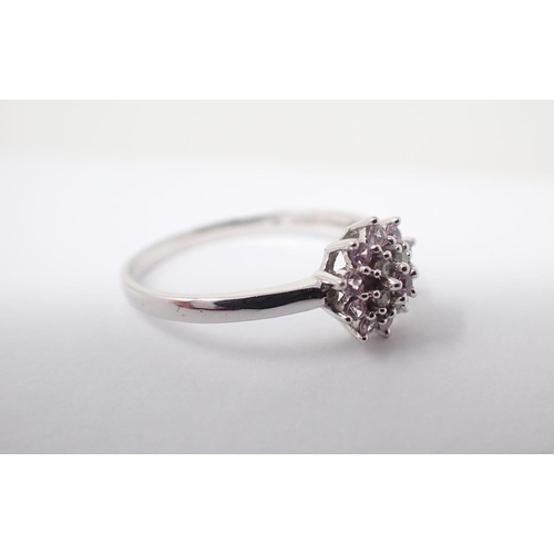 152 - A Pink and White Diamond Cluster Ring peg-set brilliant-cut stones in 9ct white gold