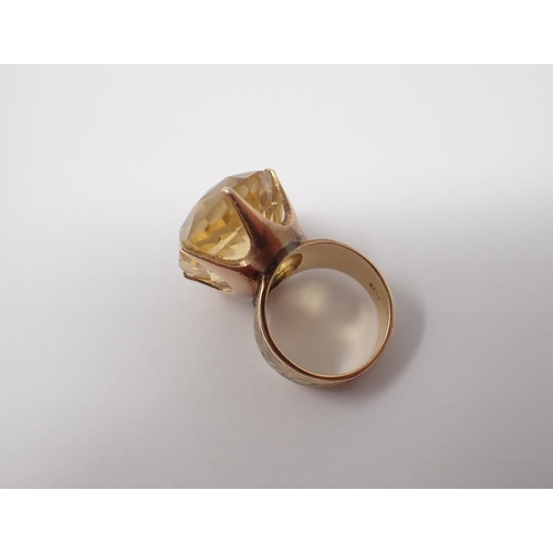 156 - A Citrine Dress Ring claw-set oval-cut mixed-cut stone, stamped 14K, ring size J