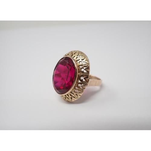 164 - A Dress Ring rubover-set large oval-cut synthetic ruby in 18ct gold ring size P 1/2