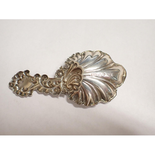 167 - A Victorian silver Caddy Spoon formed as scallop shell with scrolled handle, maker AH