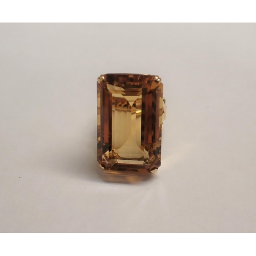 181 - A large Citrine Ring corner claw-set step-cut stone to pierced mount, stamped 750, ring size O