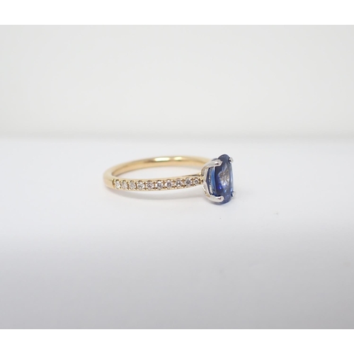 184 - A Sapphire and Diamond Ring claw-set oval-cut sapphire, 0.94cts, between graduated brilliant-cut pav... 