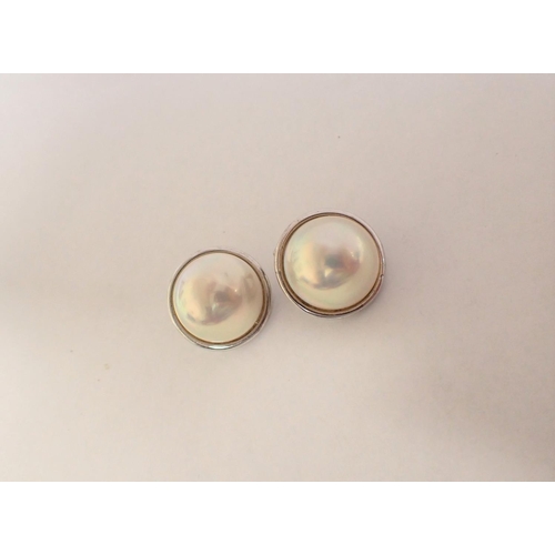 189 - A pair of Mabé Pearl Ear Clips set in silver