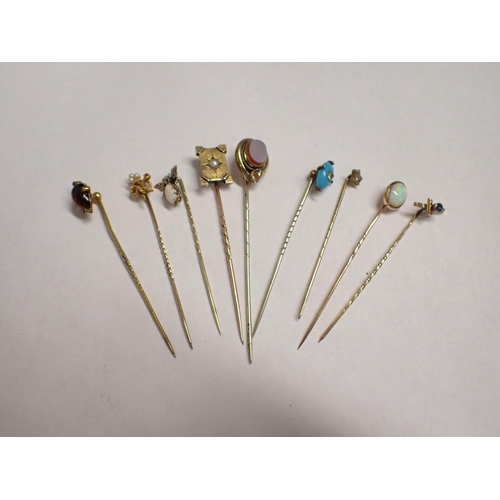 198 - Nine various gold and yellow metal Stick Pins set stones, pearls etc