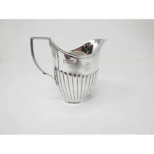 202 - A George V silver Cream Jug of oval semi-fluted form, London 1912