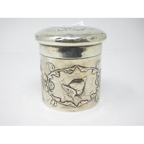 211 - An Edward VII silver cylindrical Box and Cover embossed cherubs, etc, London 1907, maker: Wm Comyns,... 