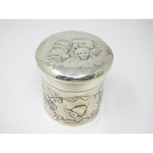 211 - An Edward VII silver cylindrical Box and Cover embossed cherubs, etc, London 1907, maker: Wm Comyns,... 