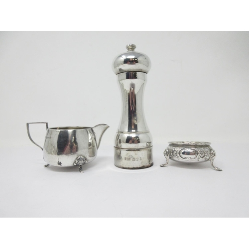 216 - A modern silver Pepper Mill, London, a small Jug, Birmingham 1909, and a Victorian Cauldron Salt flo... 