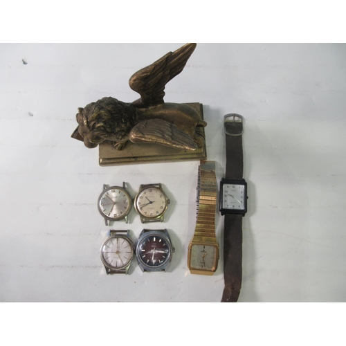 231 - A brass model of a lion on stand  A/F, and six Wrist Watches