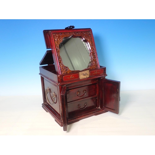 233A - A Chinese stained jewellery Box with a hinged lid enclosing a  fold out mirror, base fitted two door... 