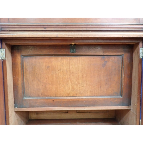 30 - An Edwardian walnut ship's Dressing Cabinet the upper section fitted pair of cupboard doors enclosin... 