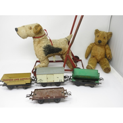 377 - Three Hornby tinplate Goods Carriages, a Chiltern Push-along Dog and a Pedigree Teddy, worn