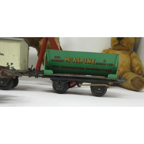 377 - Three Hornby tinplate Goods Carriages, a Chiltern Push-along Dog and a Pedigree Teddy, worn