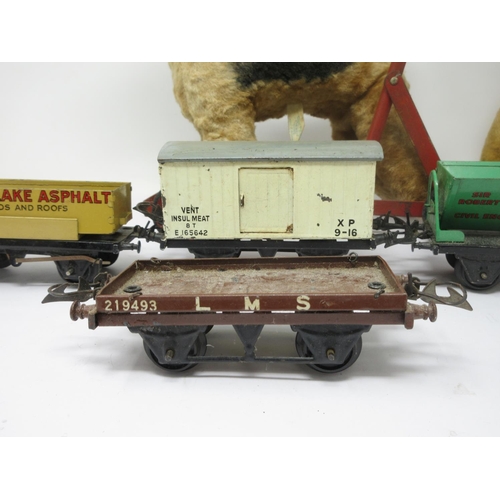 377 - Three Hornby tinplate Goods Carriages, a Chiltern Push-along Dog and a Pedigree Teddy, worn