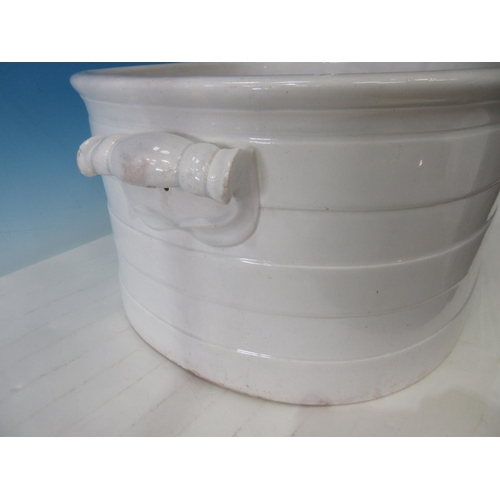 425A - A large white ceramic Footbath with moulded handles and banded design, 17 in chips to the underside ... 