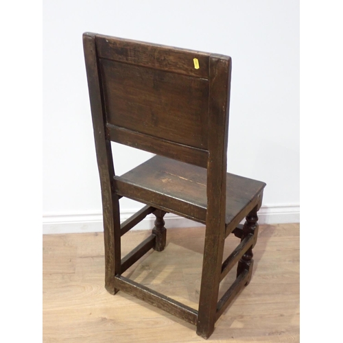 43 - A late 17th Century oak Manchester type Chair with leafage carved panel back on turned and square cu... 