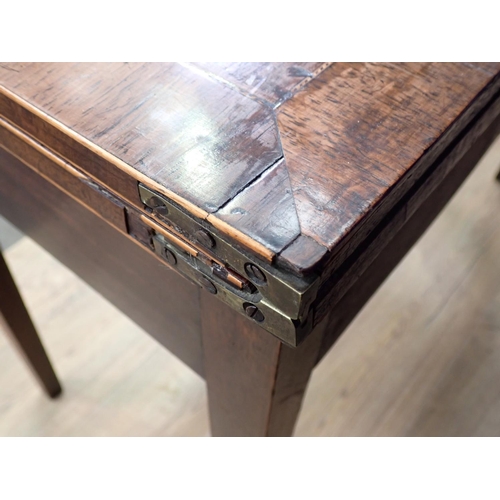 509 - A 19th Century mahogany and rosewood crossbanded fold over Card Table with shell inlay mounted upon ... 