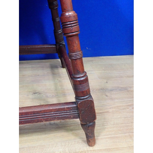 540 - An Arts and Crafts mahogany Occasional Table on ring turned supports united by surrounding stretcher... 