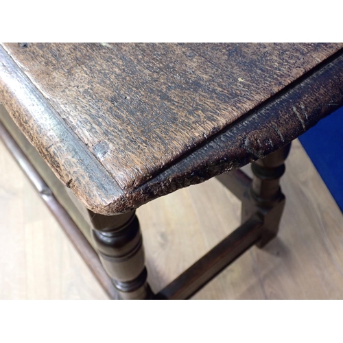 554 - An 18th Century joined oak Refectory Bench on turned supports united by surrounding stretchers 4ft 4... 