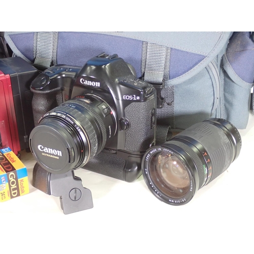 560 - A Canon EOS-1 Camera and two Lenses and a Film Camera