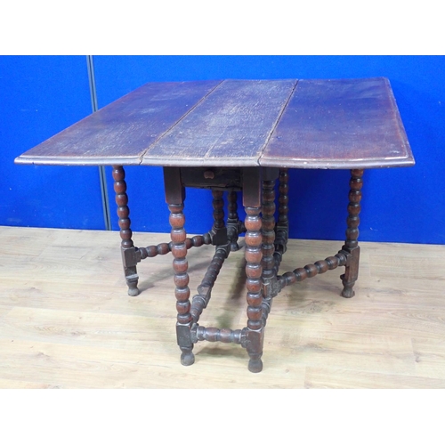 567 - A 17th Century oak Gateleg Table with rectangular moulded top on bobbin turned supports and stretche... 