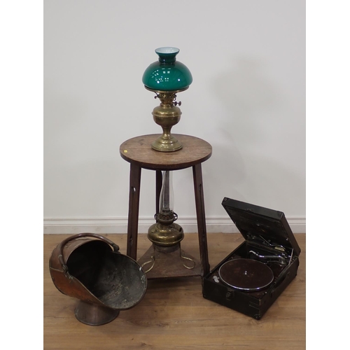 583 - An Arts and Crafts oak circular Occasional Table on three pierced supports, two brass Oil Lamps and ... 