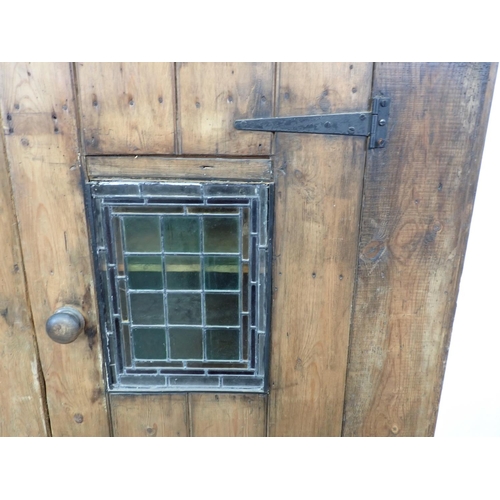 594 - An antique pine Cupboard with single door with leaded glass pane 5ft 3in H x 3ft 6in W