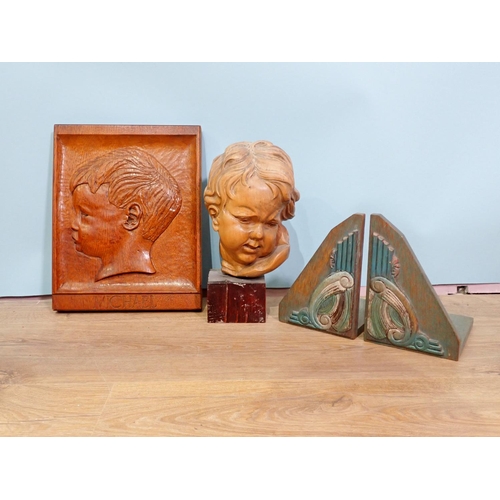 60 - A 20th Century carved oak Panel of a boy, a pair of Art Deco oak Book Ends and a carved limewood Boy... 