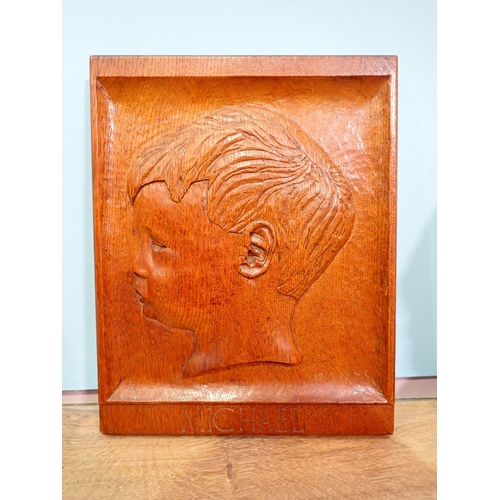 60 - A 20th Century carved oak Panel of a boy, a pair of Art Deco oak Book Ends and a carved limewood Boy... 