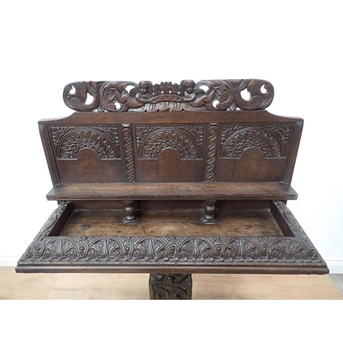 602 - An antique carved oak Console Table with arcaded back and carved cherub surmount 4ft 2in H x 3ft 1in... 