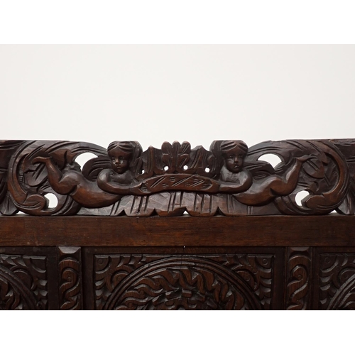 602 - An antique carved oak Console Table with arcaded back and carved cherub surmount 4ft 2in H x 3ft 1in... 