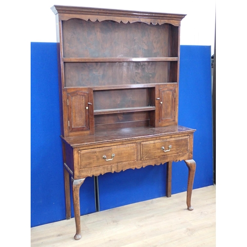 621 - An oak Dresser and Rack fitted two frieze drawers mounted upon cabriole supports and pad feet 6ft 10... 