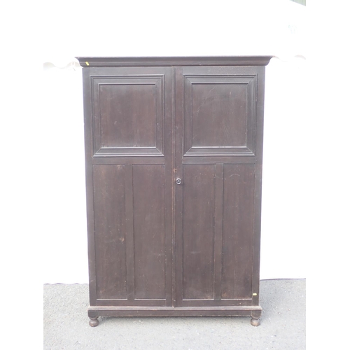 633 - A panelled oak two door wardrobe 6ft 2in H x 4ft 3in W