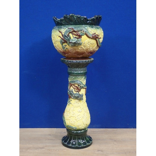 91 - A ceramic Jardinière on stand with Chinese dragon relief moulded decoration 2ft 10in H