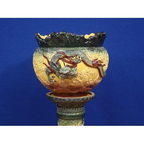 91 - A ceramic Jardinière on stand with Chinese dragon relief moulded decoration 2ft 10in H