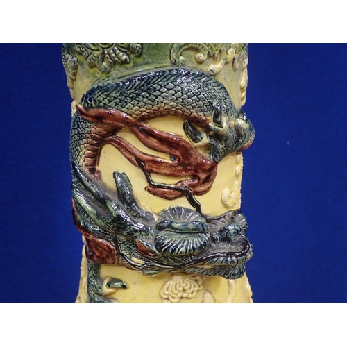 91 - A ceramic Jardinière on stand with Chinese dragon relief moulded decoration 2ft 10in H