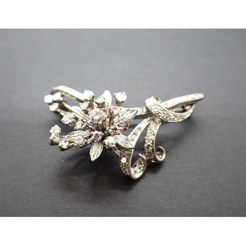 100 - A Diamond Flower Spray Brooch claw and pavé-set brilliant-cut stones and a row of channel-set baguet... 