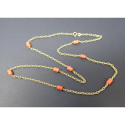 111 - A Coral Necklace having cylindrical coral links spaced along a fancy-link chain marked 18ct, approx ... 