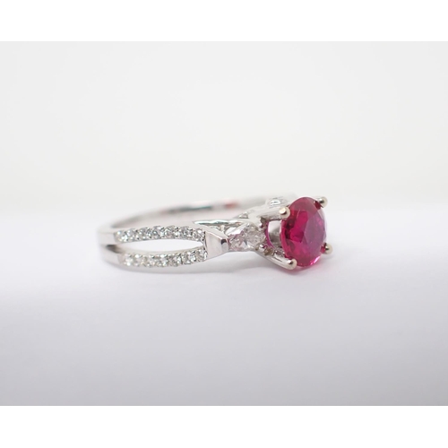 122 - A Ruby and Diamond Ring claw-set round ruby, 0.86cts, between two marquise-cut diamonds and brillian... 