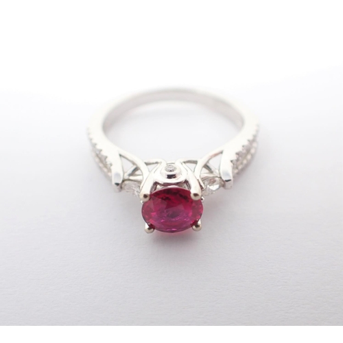 122 - A Ruby and Diamond Ring claw-set round ruby, 0.86cts, between two marquise-cut diamonds and brillian... 