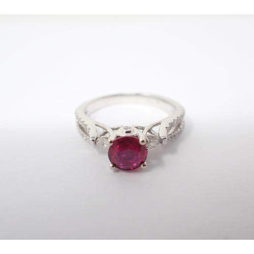 122 - A Ruby and Diamond Ring claw-set round ruby, 0.86cts, between two marquise-cut diamonds and brillian... 