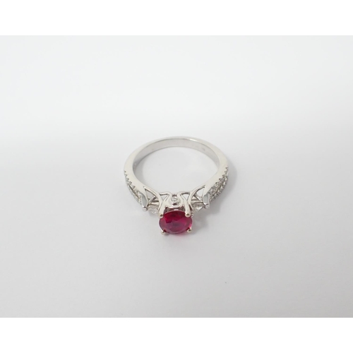 122 - A Ruby and Diamond Ring claw-set round ruby, 0.86cts, between two marquise-cut diamonds and brillian... 