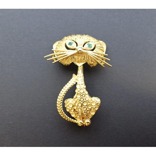 132 - A gem-set Garrard Cat Brooch the stylised cat with emerald set eyes in 18ct gold, marked G & Co, in ... 