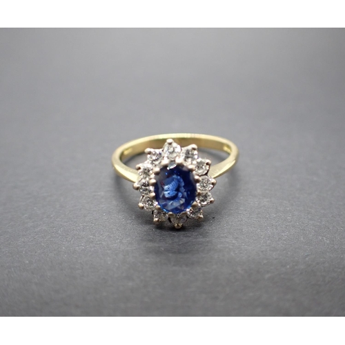 138 - A Sapphire and Diamond Cluster Ring claw-set oval-cut sapphire, 0.55cts, within a frame of brilliant... 