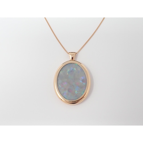 146 - An Opal Pendant set oval slice of opal, 31.80ct, in rose gold frame on fine chain in 18ct gold