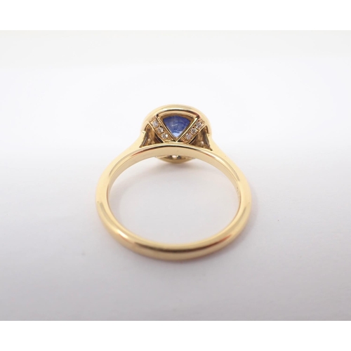 151 - A Sapphire and Diamond Cluster Ring rubover-set round sapphire, 1.00ct, within frame of pavé-set bri... 