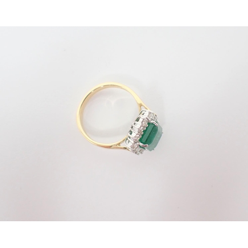 152 - An Emerald and Diamond Cluster Ring corner claw-set step-cut emerald, 3.80cts, within a frame of cla... 