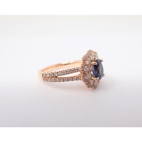 159 - A Sapphire and Diamond Cluster Ring claw-set oval-cut sapphire, 1.07cts, within frame of ten brillia... 